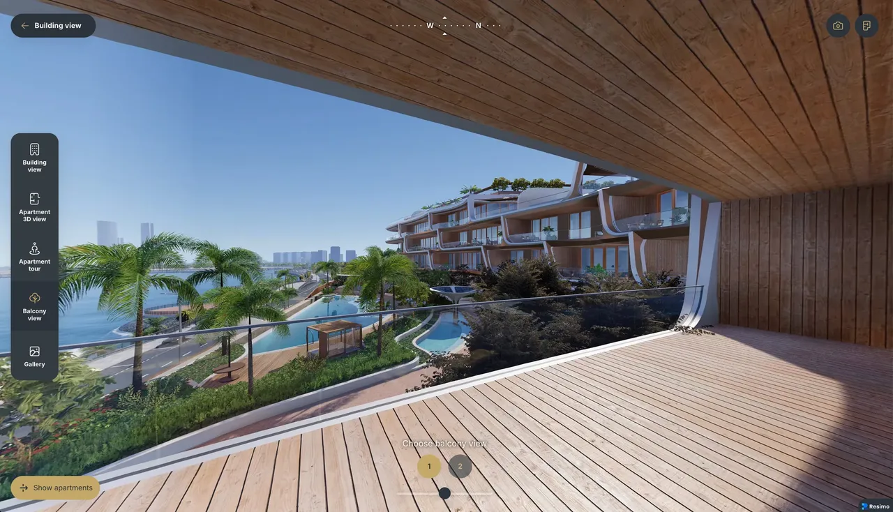 The view from an apartment balcony over the pools and the sea, inside the application