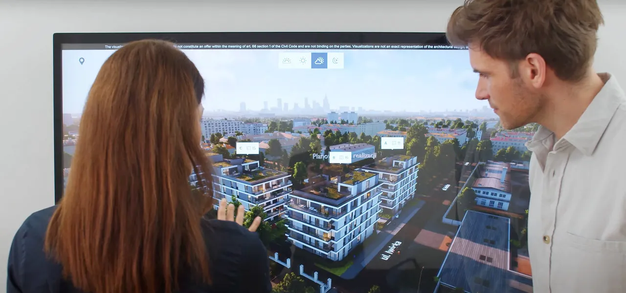 شخصان أمام شاشة كبيرة تعمل باللمس تعرض مشروعا سكنيا بتقنية 3D