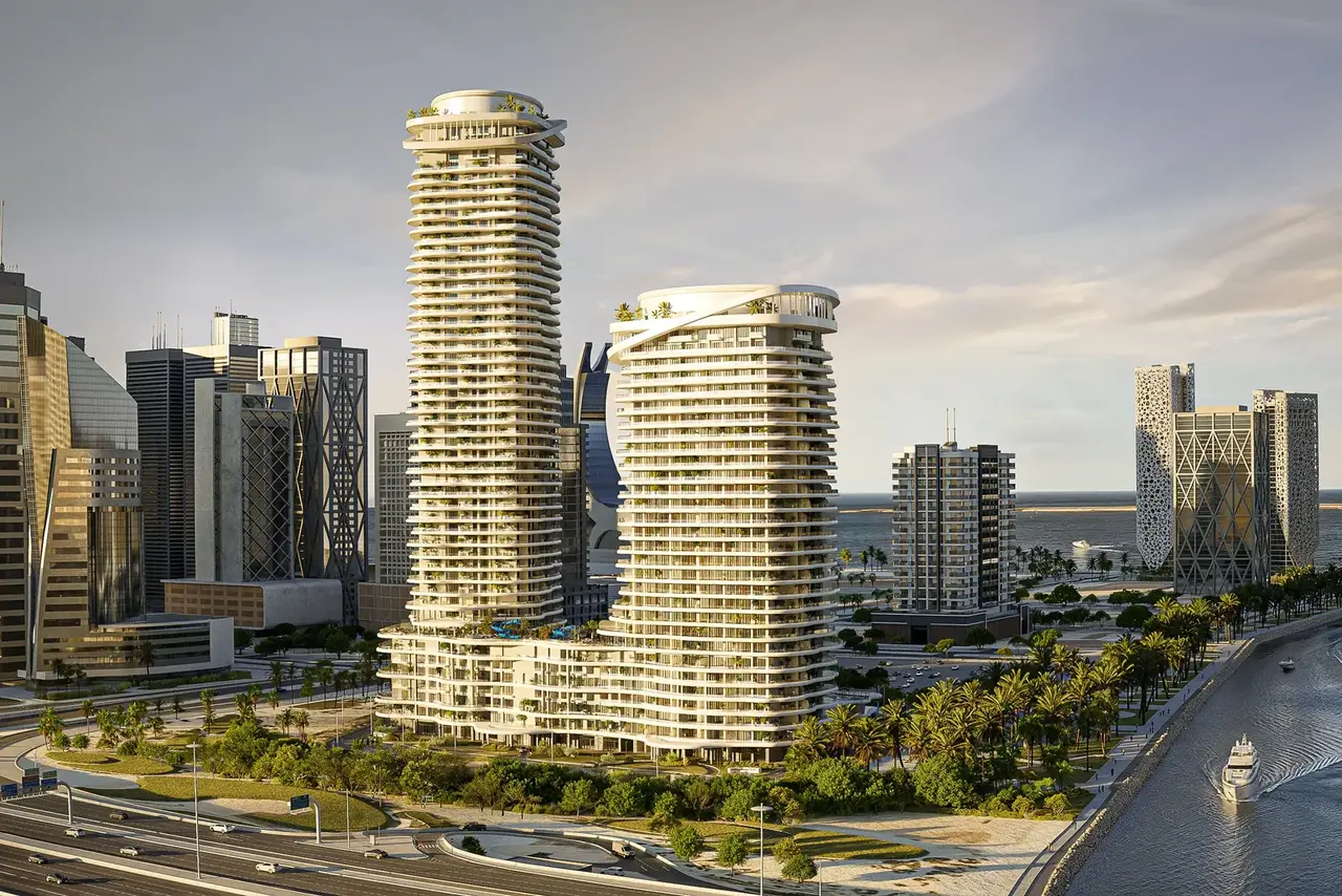 Aerial render of twin round residential towers on a waterfront boulevard